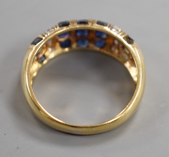 A modern yellow metal, sapphire chip and diamond chip set half hoop cluster ring, size M/N, ross weight 3.6 grams(two sapphires missing).